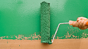 paint roller spreading green paint